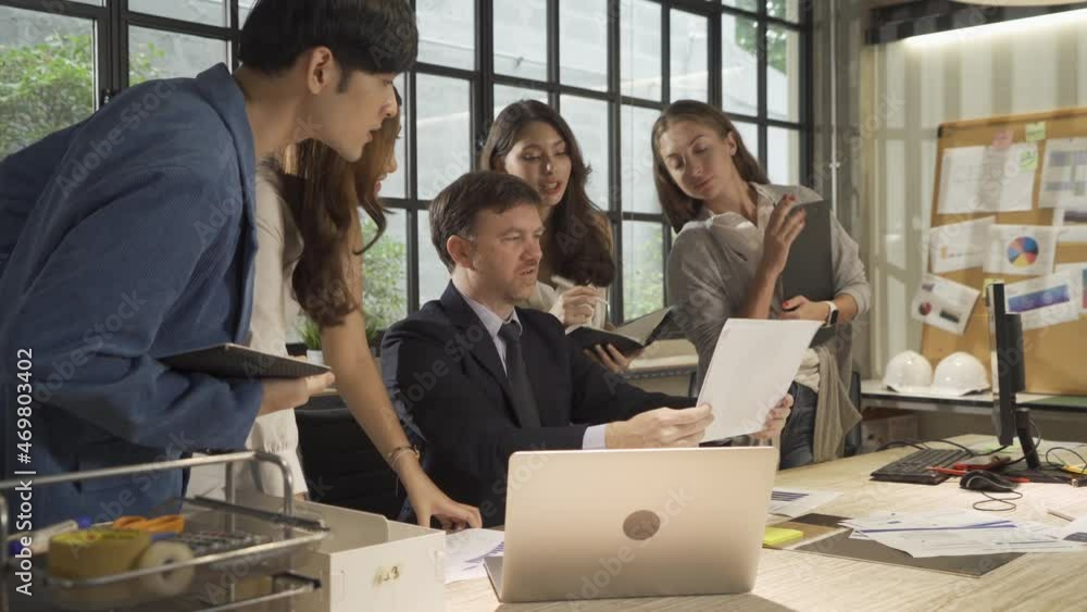A group of multi ethnic business team talk, communicate, discuss, and work in meeting room in office, present ideas with a computer technology device to colleagues. People lifestyle. Corporation A group of multi ethnic business team talk, communicate, discuss, and work in meeting room in office, present ideas with a computer technology device to colleagues. People lifestyle. Corporation