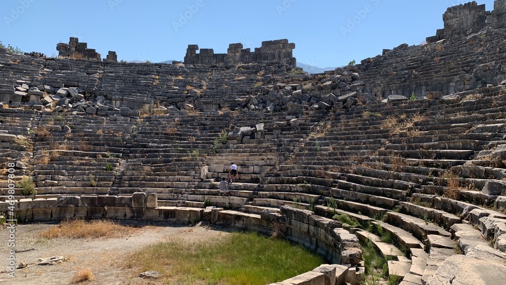 Ruins of an ancient amphitheater. Roman amphitheater in Turkey.Ancient stones of the excavated historic city. Turkey, Fetiya, August 13, 2021