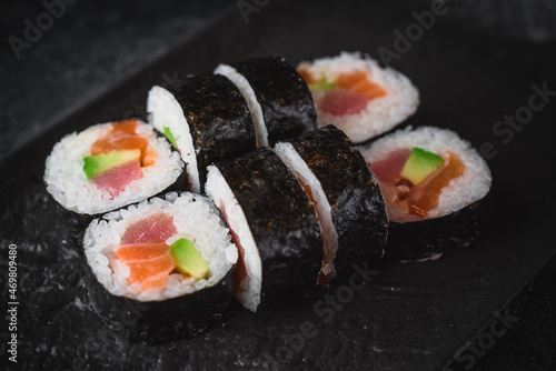 sushi on a black plate futo maki