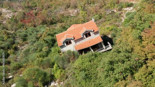 Leaning house, tilted due to weak and collapsed foundation. Building on unstable ground and terrain prone to landslide.