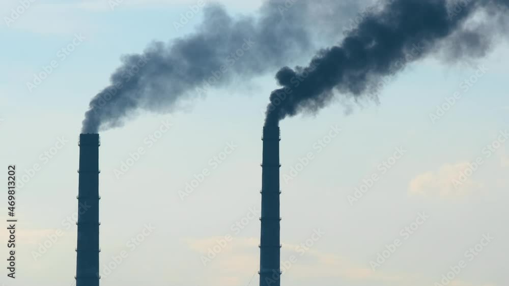 Coal power plant high pipes with black smoke moving upwards polluting atmosphere. Production of electrical energy with fossil fuel concept Coal power plant high pipes with black smoke moving upwards polluting atmosphere. Production of electrical energy with fossil fuel concept