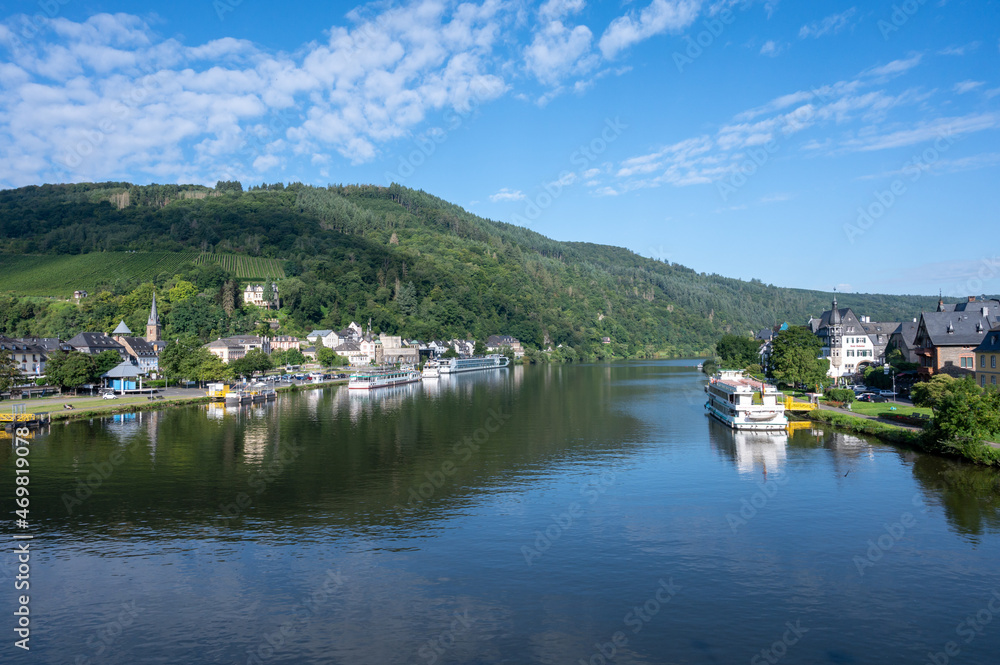 View on Mosel river, hills with vineyards and old town Traben-Trarbach, Germany