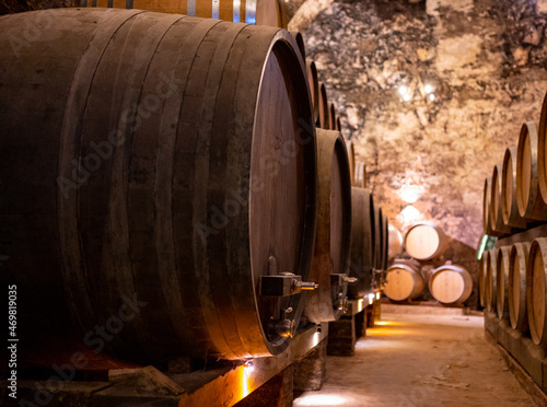 Medieval underground wine cellars with old red wine barrels for aging of vino nobile di Montepulciano in old town Montepulciano in Tuscany, Italy photo
