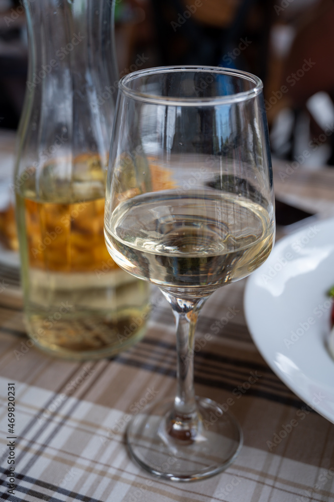 Dinner with white wine in small Greek taverna