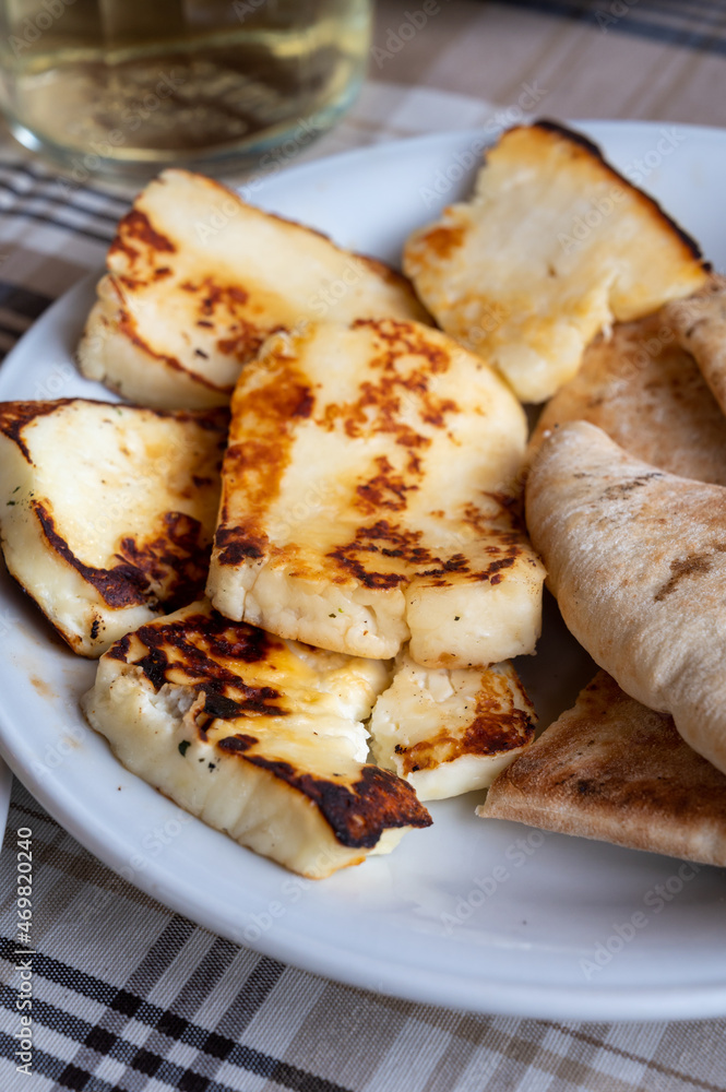Traditional roasted or grilled halloumi cheese from Cyprus served hot with flat bread Traditional roasted or grilled halloumi cheese from Cyprus served hot with flat bread