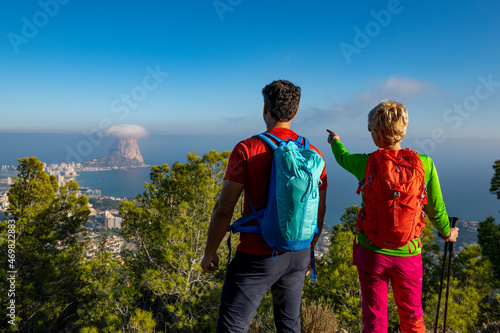 Couple hiking on Oltá mountain, Calpe, Alicante, Spain photo