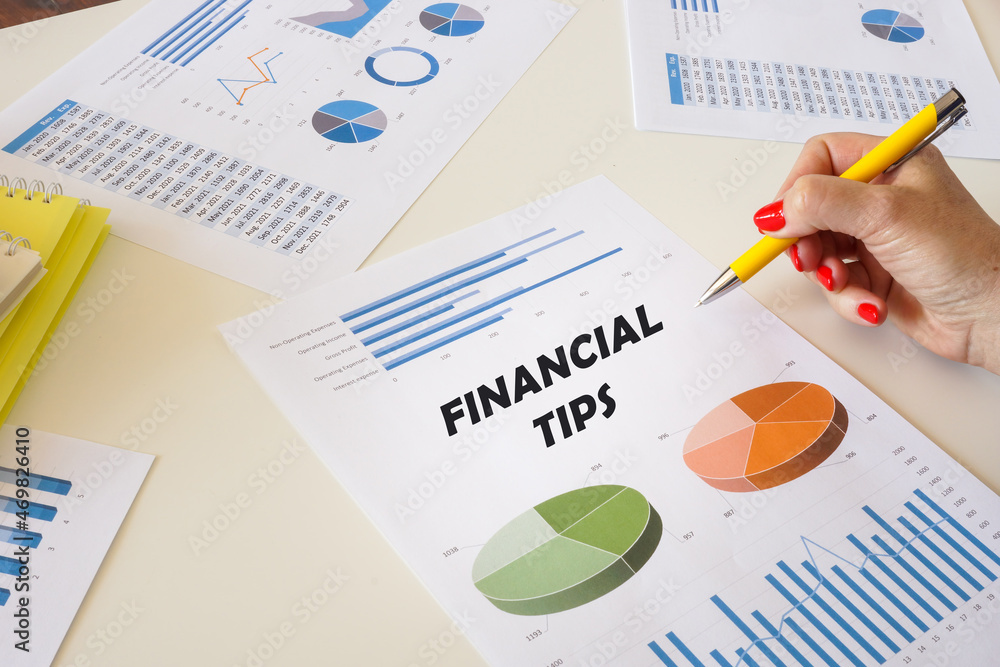 Financial concept meaning FINANCIAL TIPS with sign on the financial document. Financial concept meaning FINANCIAL TIPS with sign on the financial document.