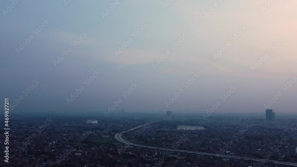 aerial drone shot of a city at night with twilight sky aerial drone shot of a city at night with twilight sky