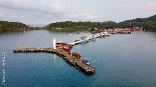 High angle view of Bang Bao Pier in the morning at Ko Chang District, Trat. There is a white lighthouse at the end of the marina. photo