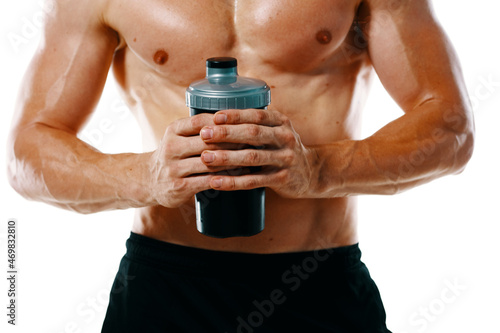 athletic man with a pumped-up torso drink bottle sportspit
