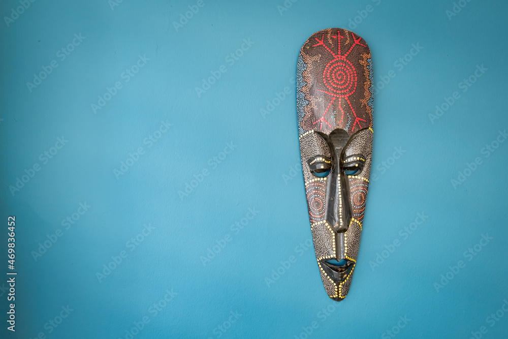 Tribe mask on the wall. African tribal mask, wooden black mask of indigenous people Tribe mask on the wall. African tribal mask, wooden black mask of indigenous people