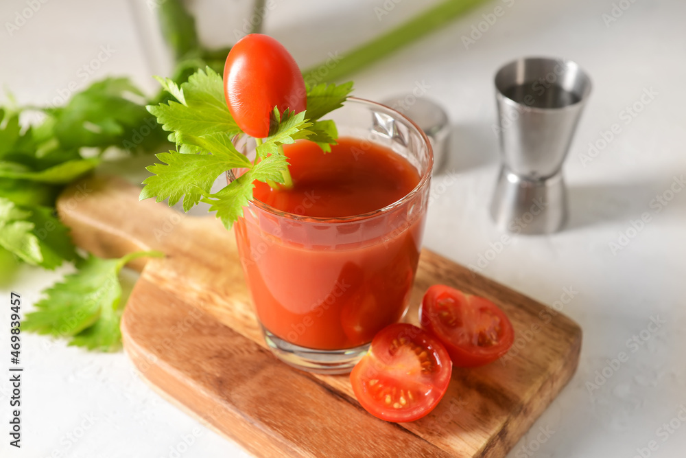 Board with glass of bloody mary on light background Board with glass of bloody mary on light background