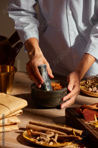 Fotografie Traditional chinese medicine with herb and spices in brown wooden background doc