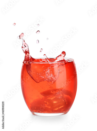 Glass of classic negroni cocktail with splashes on white background