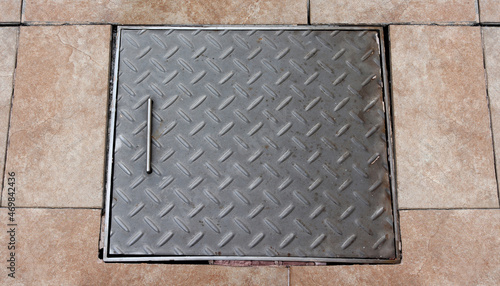 Old checkered steel manhole cover