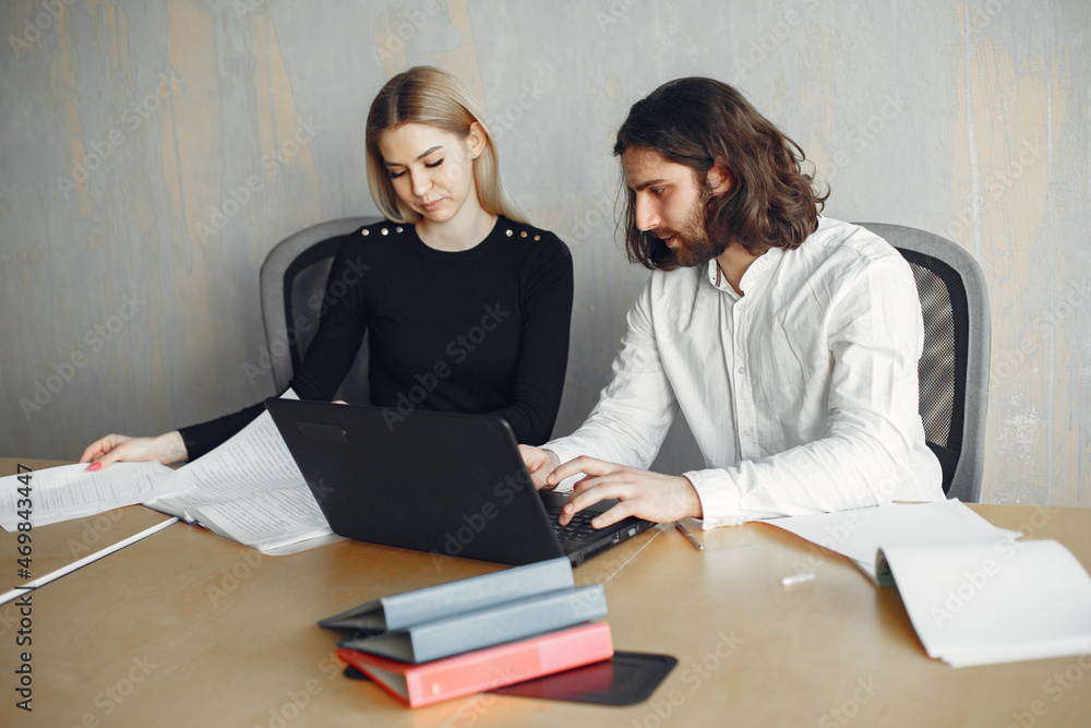 Stylish businessman with woman working at the office Stylish businessman with woman working at the office