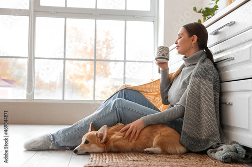 Young woman with cute Corgi...