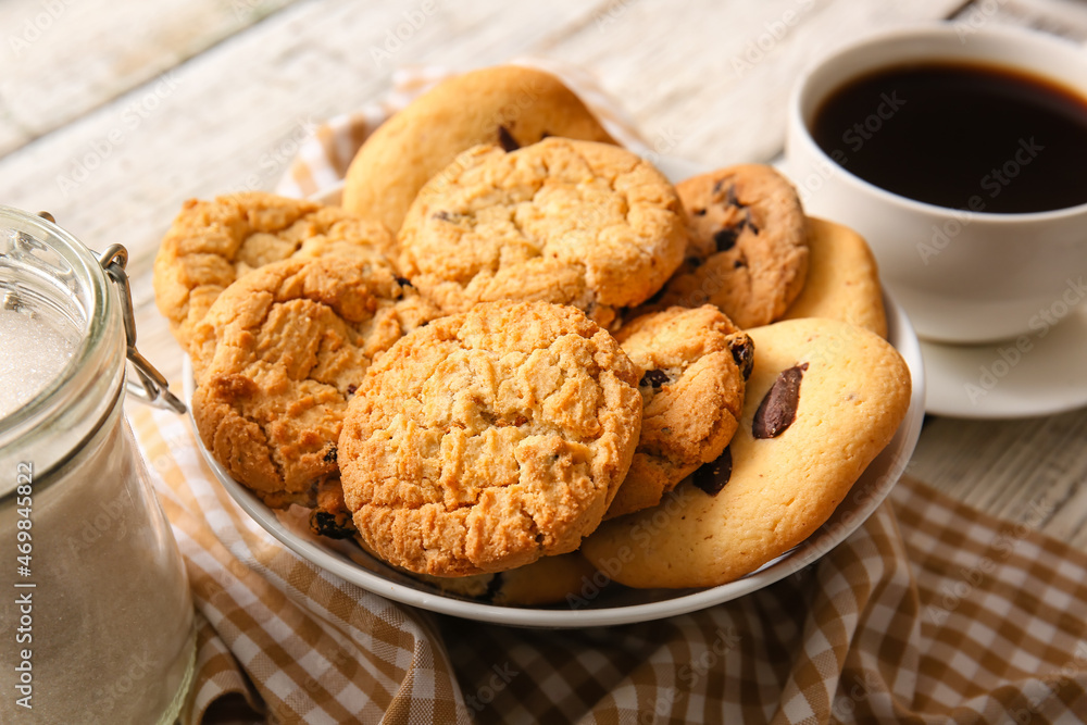 Bowl with tasty homemade cookies with chocolate chips on white wooden background Bowl with tasty homemade cookies with chocolate chips on white wooden background