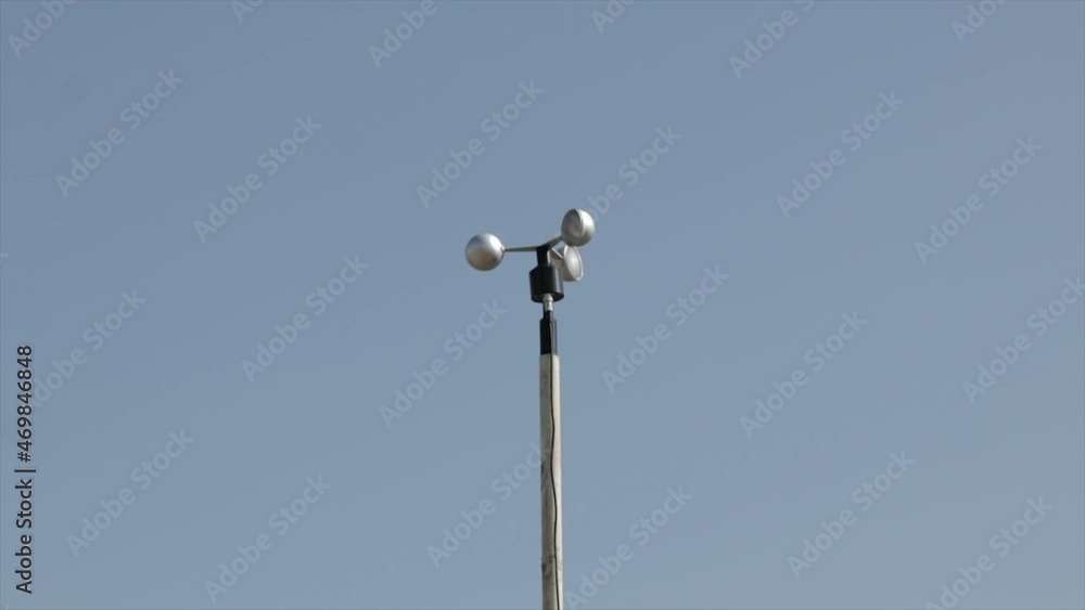 Anemometer spinning on the wind measuring the wind speed and direction. Meteorology instrument. Air station. Anemometer spinning on the wind measuring the wind speed and direction. Meteorology instrument. Air station.
