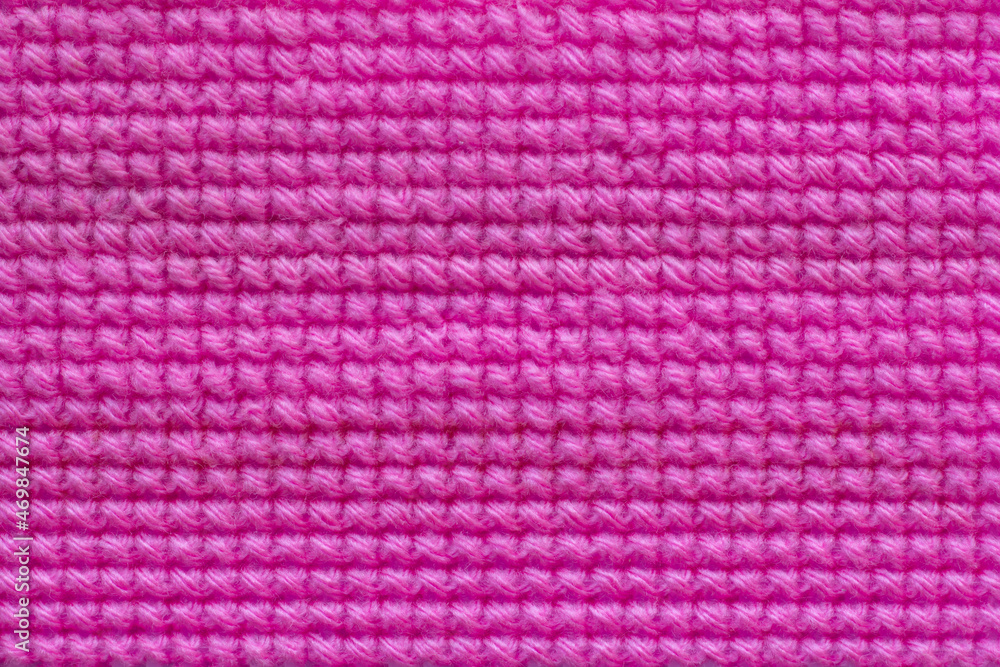 Pink yarn embroidered with a cross pattern on Plastic mesh canvas or vinyl weave to do invention for backgrounds and textures. Pink yarn embroidered with a cross pattern on Plastic mesh canvas or vinyl weave to do invention for backgrounds and textures.