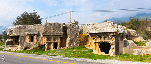 Photo View of rock burial chambers ruins in antique Lycian settlement of Araxa, Oren v