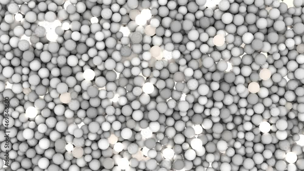 An abstract composition of gray matte balls that continuously glow with bright neon light.