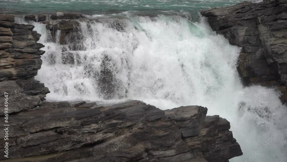 Athabasca River Falls, Jasper National Park, Alberta, Canada. Cascade Waterfall on Autumn Day, Close Up Athabasca River Falls, Jasper National Park, Alberta, Canada. Cascade Waterfall on Autumn Day, Close Up