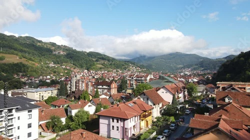 Flying Above Houses and Apartment Buildings in Sunny Ivanjica Cityscape, Serbia. Drone Aerial View photo