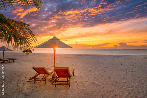 Romantic tropical beach banner. White sand and coco palm leaves over chairs and umbrella, couple travel tourism. Amazing beach landscape, sunset sunrise shoreline, seascape colorful sky