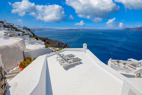 Amazing terrace landscape, caldera view Santorini, Greece with chairs loungers. Romantic couple destination with idyllic blue sky, clouds wonderful summer scenery, travel vacation, holiday. Inspire