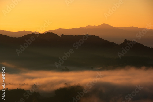 Beautiful fog and golden light in the morning forest with green mountains. Baan Jabo  Mae Hong Son  Thailand.