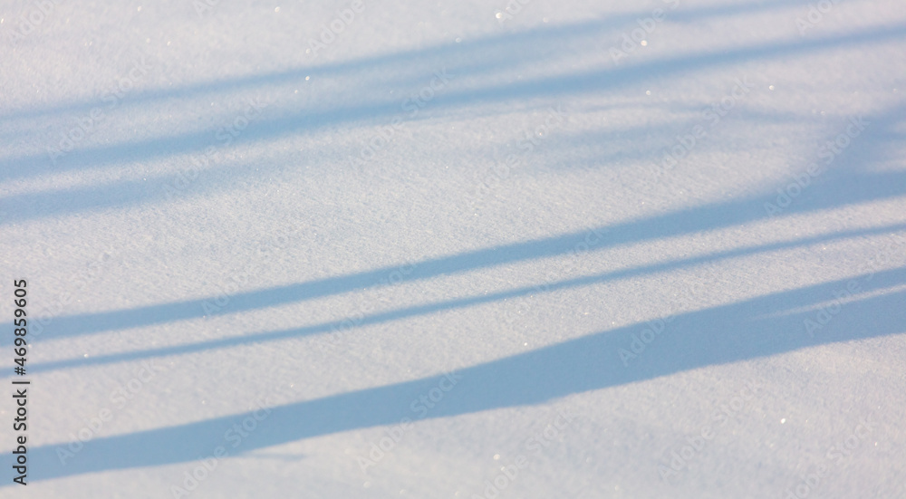 Shadow from trees on the snow as an abstract background.