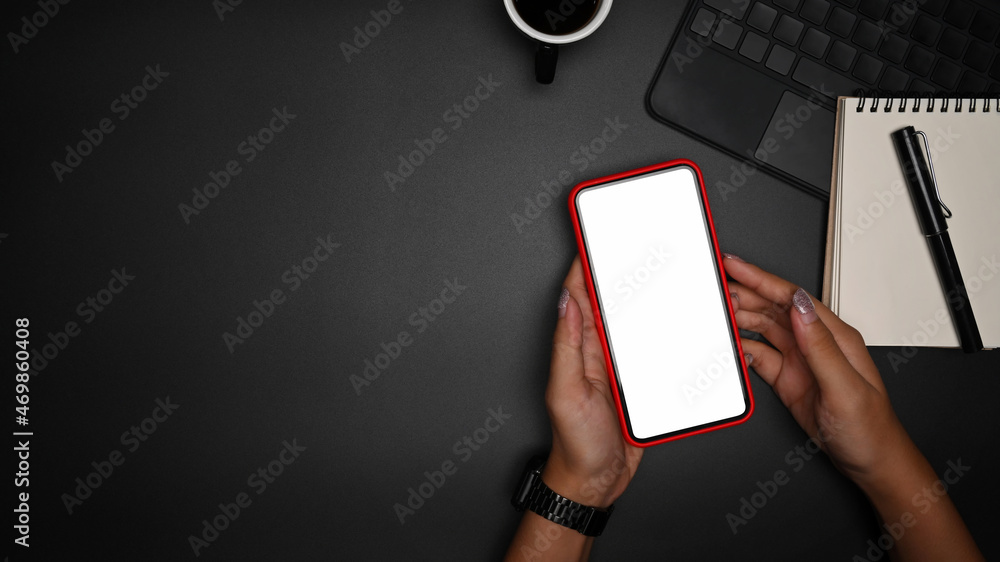 Above view businesswoman holding smart phone with blank screen. Above view businesswoman holding smart phone with blank screen.