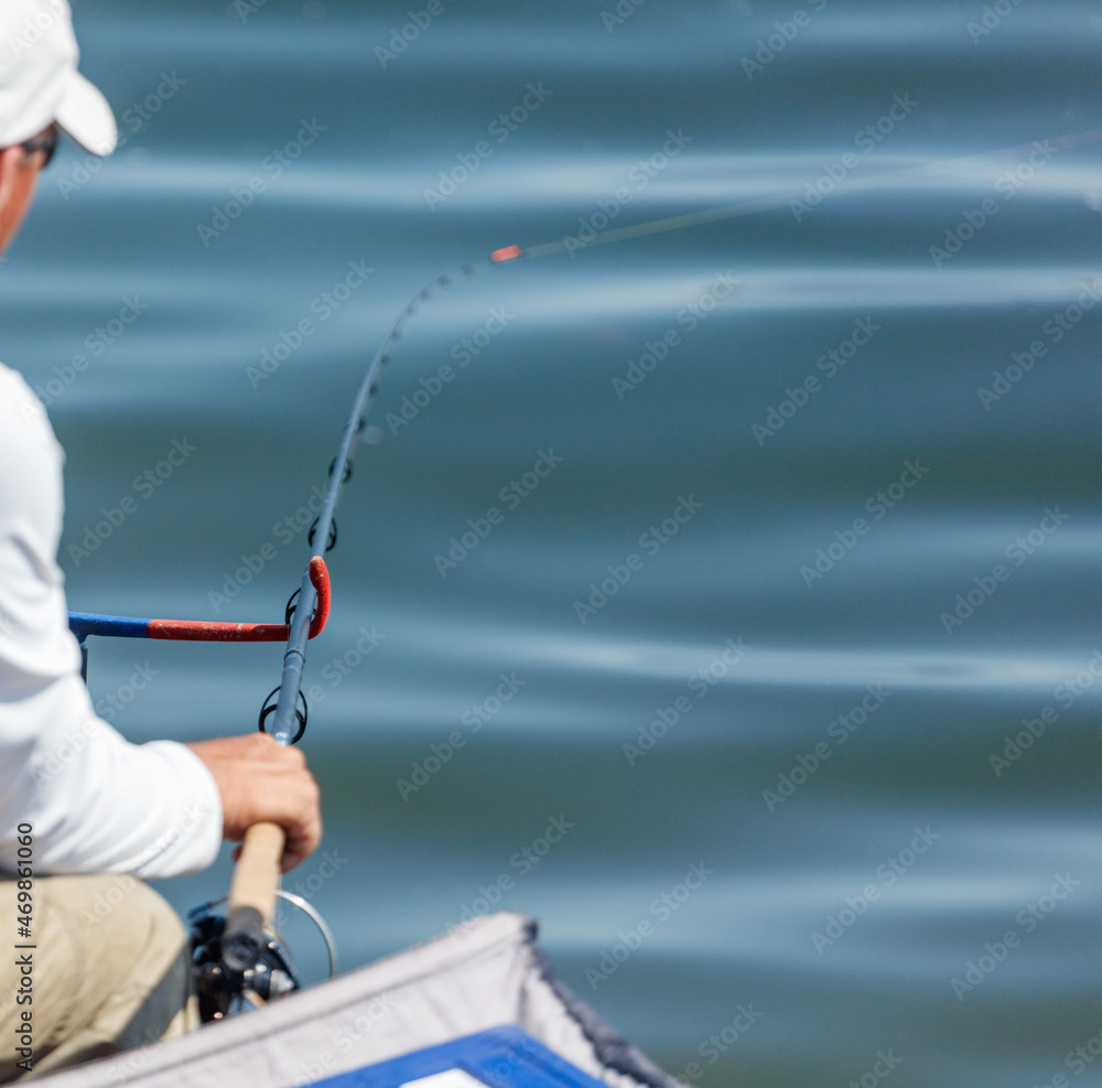 A man fishing with a rod A man fishing with a rod