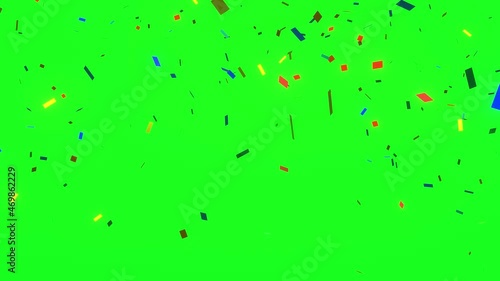 Confetti falling on a green screen, chroma key for video editing. 