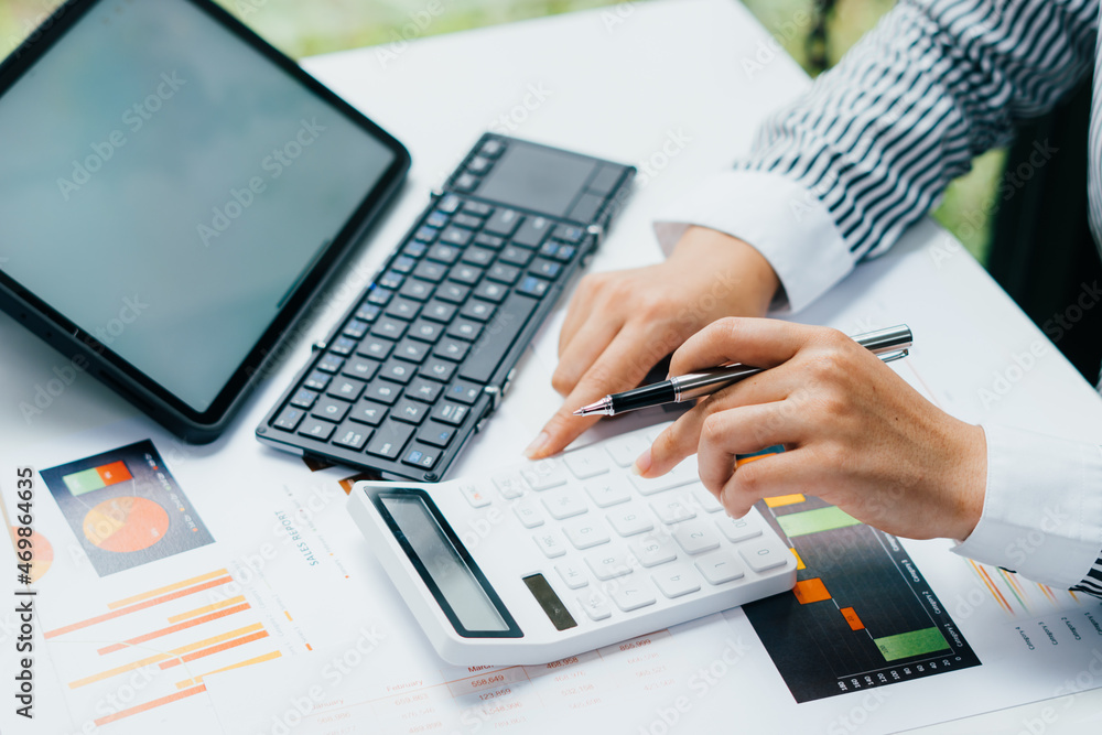 accountant working on desk using calculator for calculate finance report in office accountant working on desk using calculator for calculate finance report in office