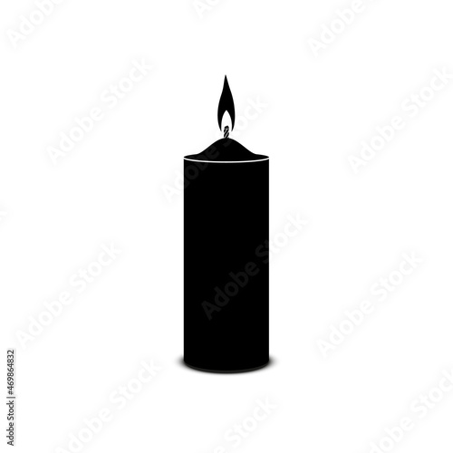 Burning paraffin candle in black on a white background.