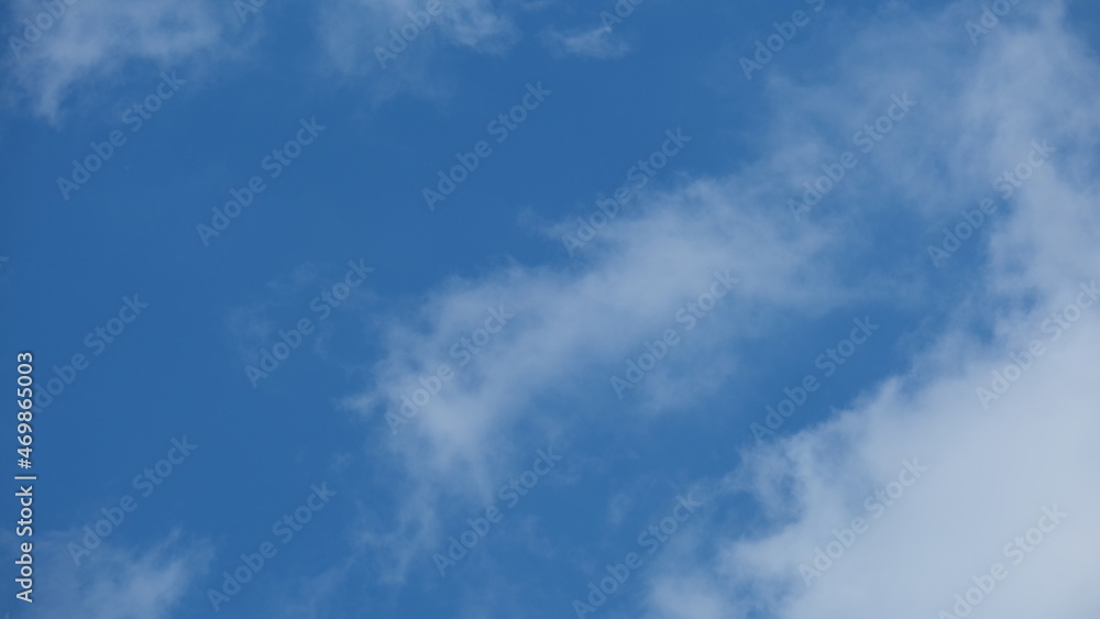 View of beautiful blue sky background with white clouds at the noon, Bangkok, Thailand.