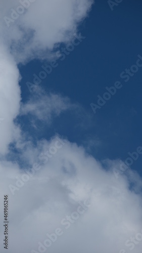 View of beautiful blue sky background with white clouds at the noon, Bangkok, Thailand.