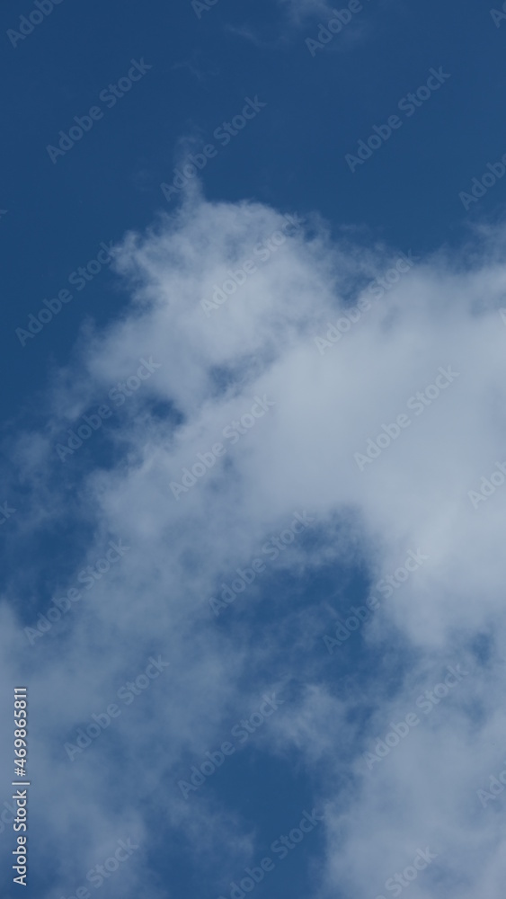 View of beautiful blue sky background with white clouds at the noon, Bangkok, Thailand.