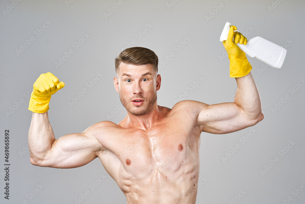 pumped up man posing with detergent in rubber gloves pumped up man posing with detergent in rubber gloves