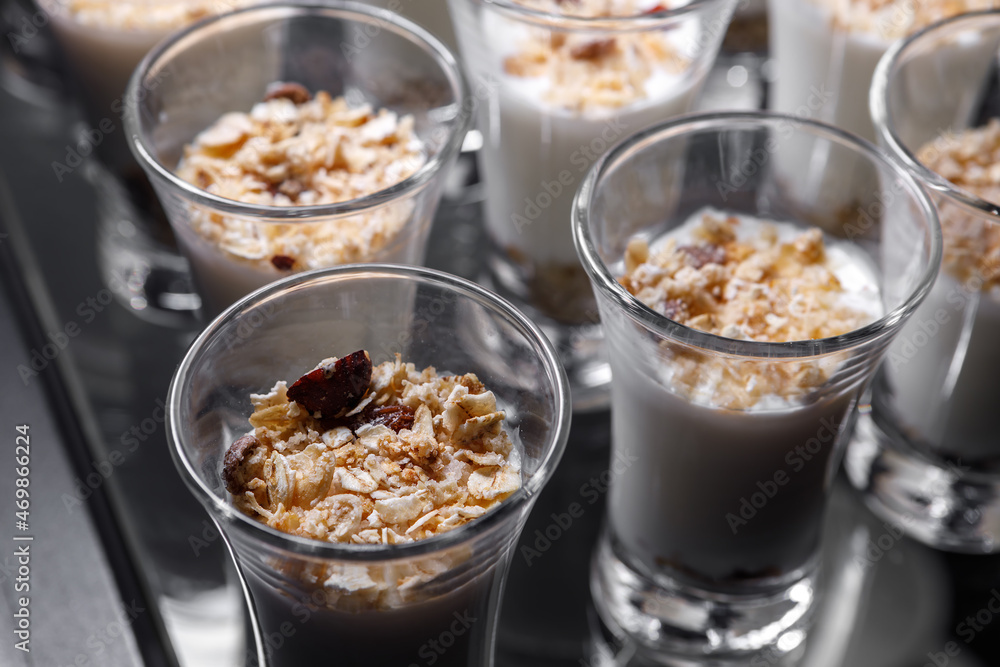 Creamy dessert of nuts in a glass stack on a dark background. Creamy dessert of nuts in a glass stack on a dark background.