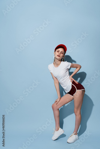 woman in summer clothes home studio teen blue background