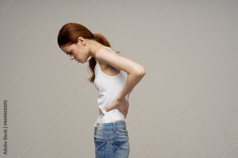 woman in white t-shirt chiropractic rheumatism health problems light background woman in white t-shirt chiropractic rheumatism health problems light background