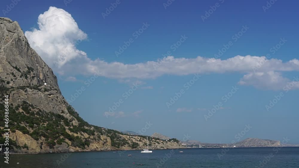 Timelapse of clouds coming out of rock and moving along amazing beauty sea bay surrounded by towering cliffs. Admiring natural beauty while traveling (Black Sea, Crimea, Sudak-Liman bay) Timelapse of clouds coming out of rock and moving along amazing beauty sea bay surrounded by towering cliffs. Admiring natural beauty while traveling (Black Sea, Crimea, Sudak-Liman bay)