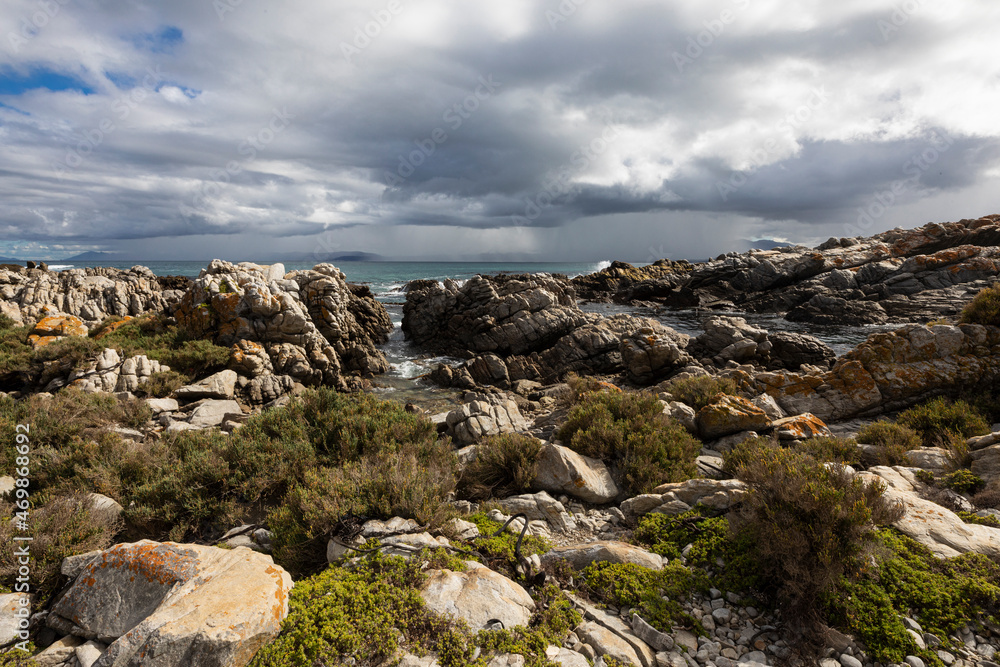 Rocky jagged coastline, eroded sandstone rock, view out to the ocean Rocky jagged coastline, eroded sandstone rock, view out to the ocean