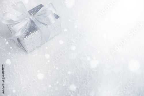 Silver Christmas gifts with snow background. silver decorations on pastel silver background. Flat lay, top view, Presents for Birthdays. Boxes with gifts tied with ribbon and bows. happy new year 2022