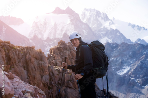Man is hiking, climbing in the beautiful mountains.