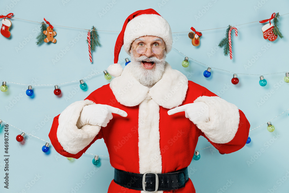 Old bearded Santa Claus man 50s in Christmas hat red suit clothes point index finger on himself isolated on plain blue background studio Happy New Year 2022 celebration merry ho x-mas holiday concept Old bearded Santa Claus man 50s in Christmas hat red suit clothes point index finger on himself isolated on plain blue background studio Happy New Year 2022 celebration merry ho x-mas holiday concept