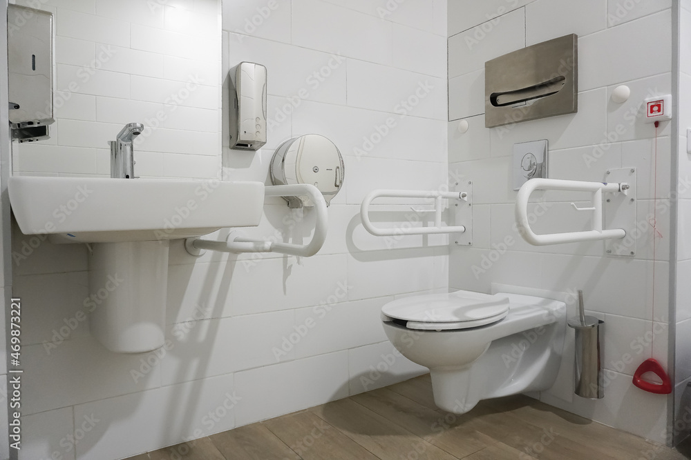 Public toilet for disabled people and people with disabilities. Special handrails and an emergency call button for clinic staff Public toilet for disabled people and people with disabilities. Special handrails and an emergency call button for clinic staff